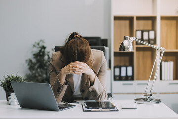 Asian women sitting in an office With stress and eye strain Tired, portrait of sad unhappy tired...