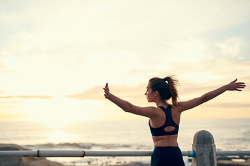 Back, woman and arms in air for sunset at beach for fitness, exercise and freedom in summer....
