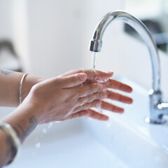 Water, person and hands in bathroom for hygiene, cleaning and protection from germs at home. Health...