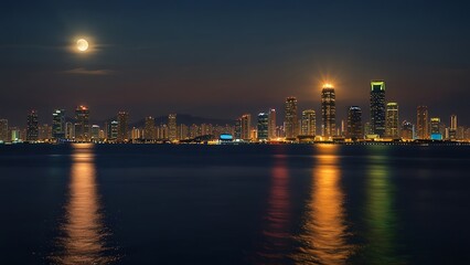 Fototapeta premium the view of the sparkling city at night seen from the sea in summer