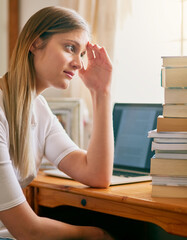 Student, woman and worried with books in home, elearning and laptop for education or overwhelmed...