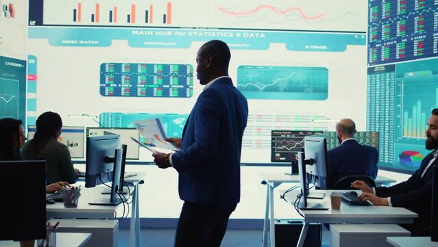 Corporate analysts looking into project details and timetables, team leader providing flyers with budget and operations plan to achieve business goals in a competitive environment. Camera B.