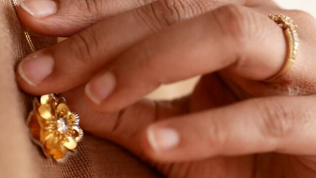 a locket around young woman's neck, close-up.