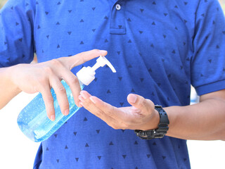 Close up view of man person using algohal gel pump for cleaning hand