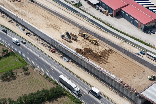 Romania A1 highway construction site. Aerial view of A1 road that connects Bucharest Pitesti highway with Curtea de Arges and Sibiu. Infrastructure construction industry in Romania.