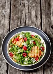 grilled pear salad with cheese, arugula, berries