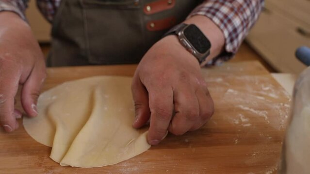 a male chef makes kutab dough in a home kitchen