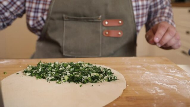 a male chef makes kutab dough in a home kitchen