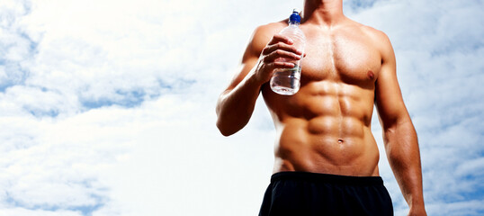 Man, body or athlete shirtless with blue sky and water bottle for wellness, exercise or workout....