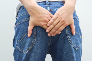 concept of health problems woman has hemorrhoids