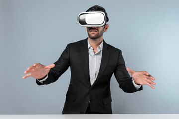 Skilled businessman looking at financial chart while wearing VR goggle. Professional project...