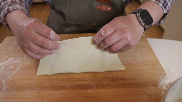 a male chef makes kutab dough in a home kitchen