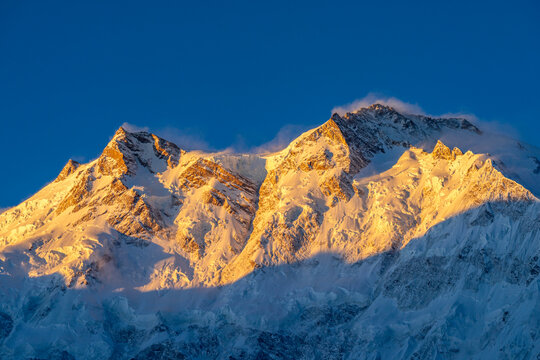First morning light touch a Nanga Parbat, meaning "naked mountain" in Urdu and locally called Diamer, or "King of the Mountains," Located just southeast of the Indus River in Gilgit-Baltistan.