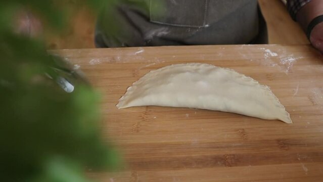 a male chef makes kutab dough in a home kitchen