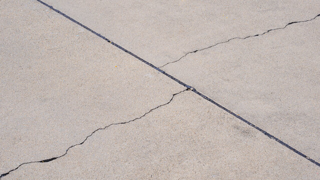 Two crack lines texture on surface of concrete pavement floor background