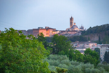 Obraz premium Siena, medieval town in Tuscany, with view of the Dome & Bell Tower of Siena Cathedral, Mangia Tower and Basilica of San Domenico, Italy