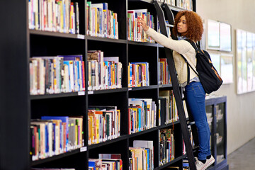 Black student, books and choice on shelf at library for research, reading or studying education of...