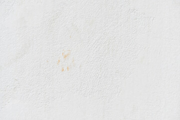White uneven render stucco concrete wall with cat footprint or paw print stains. Grunge and rough...