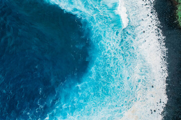 Aerial view of rough ocean with waves and volcanic beach, porto Moniz Madeira, Portugal