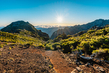 Hiking on the highest peak of Madeira Pico Ruivo next to the cottage Abrigo do Pico Ruivo. Views of...