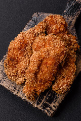 Delicious fresh crispy chicken nuggets on a dark concrete background
