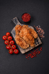 Delicious fresh crispy chicken nuggets on a dark concrete background