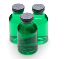 Medical medicine bottles with green liquid with syringe friendly plastic cap