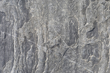 Stone texture worn by the wind and the sea of ​​the coast located on a wild beach.
