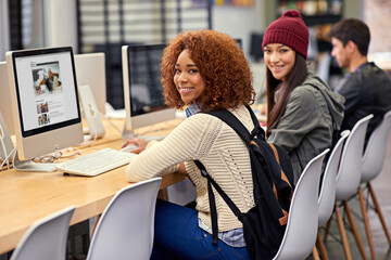 Portrait, computer and students in library for research, studying and youth in university for knowledge. College, friends and girls with smile, typing and monitor for project, exam and scholarship