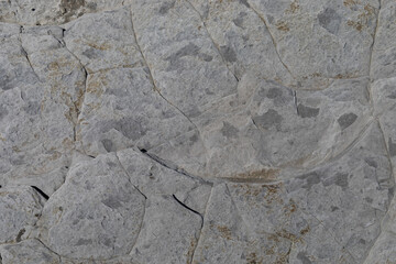 Stone texture worn by the wind and the sea of ​​the coast located on a wild beach.