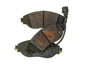 Three used brake pads on a white background.