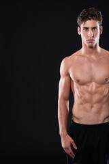 Fototapeta premium Body, fitness and space with portrait of man in studio isolated on black background for health or wellness. Exercise, mockup and muscle with shirtless or strong athlete in dark for training workout