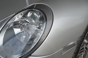 Car headlight close-up. Luxury vehicle detail of headlight.