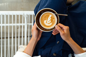 Overhead view of elegant woman drinking morning coffee