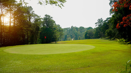 Golf course at sunset with beautiful sky.