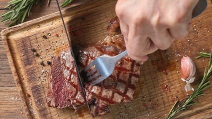 Chef slicing freshly grilled juicy beef steak