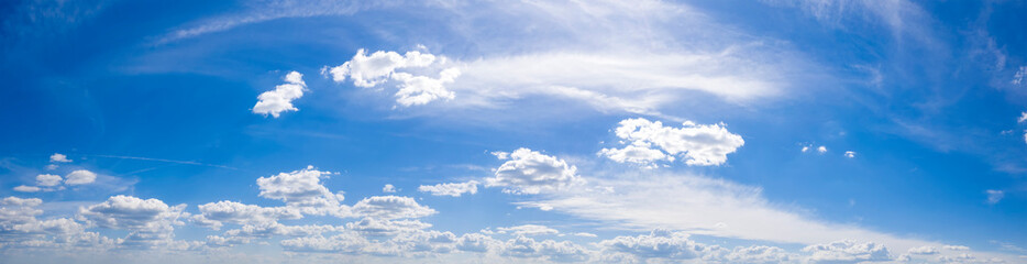 Panoramic view of blue sky with clouds and sunlight