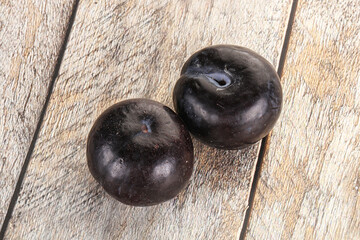 Two ripe sweet black plums