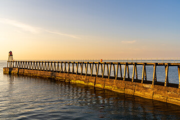 Fototapeta premium The East Pier in Whitby, England, UK