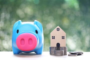 Finance, Model house with piggy bank and stack of coins money on natural green background,Business...