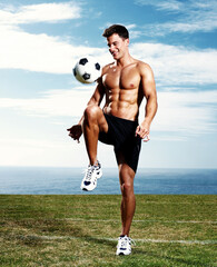Man, soccer player and ball with knee on field or summer training or match practice, football or...