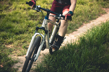 Woman mountain biking on mountain trail