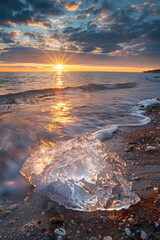 Fototapeta premium a iceberg is sitting down on the shore of a beach, in the style of luminous hues, swirling vortexes, zeiss batis 18mm f/2.8, orange and blue, uhd image, light blue and gold, aurorapunk 