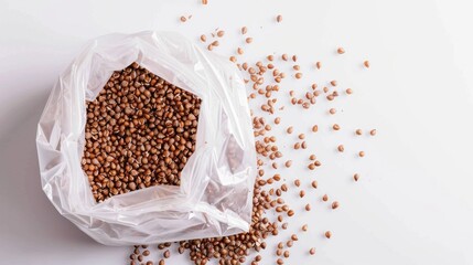Buckwheat in a plastic bag against a white backdrop