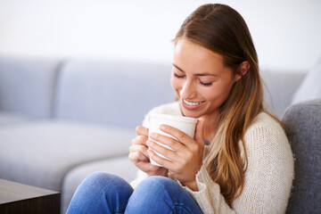 Happy, woman or coffee in living room for relax, peace or cappuccino in morning. Female person,...