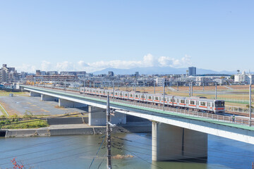 train running on the bride on tama river in tokyo in sunny day