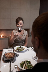 Woman, dinner and date with wine, drinking and romantic for connection, relationship and bonding as couple. Female person, smile and cheers with man for meal, celebration or anniversary at restaurant