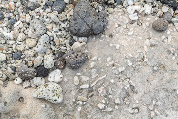 Beachrock is a friable to well-cemented sedimentary rock that consists of a variable mixture of basalt gravel , sand , and silt-sized sediment. fragments of coral and shells . Geology 
