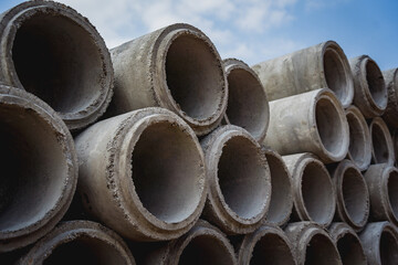 A stack of concrete ring pipes piled and creating a symmetrical arrangement