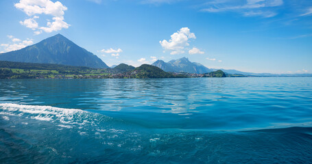 panorama landscape lake Thunersee, from boat trip, blue sky with clouds. switzerland